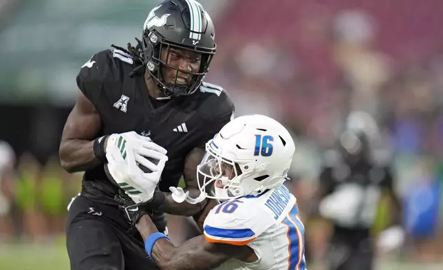 South Florida wide receiver Keshaun Singleton (11) Boise State defensive back Franklyn Johnson Jr. (16) to score during the second half of an NCAA college football game Thursday, Aug. 28, 2025, in Tampa, Fla. (AP Photo/Chris O'Meara)