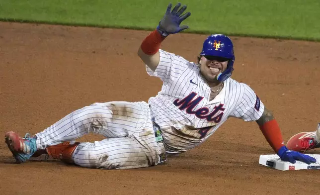 New York Mets catcher Francisco Alvarez grimaces after being injured sliding into second during the seventh inning of the Little League Classic baseball game against the Seattle Mariners at Bowman Field in Williamsport, Pa., Sunday, Aug. 17, 2025. (AP Photo/Gene J. Puskar)