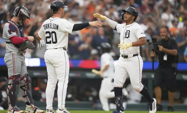Detroit Tigers' Wenceel Perez, right, celebrates with Spencer Torkelson (20) after hitting a tying two-run home run during the fifth inning of a baseball game against the Minnesota Twins, Monday, Aug. 4, 2025, in Detroit. (AP Photo/Ryan Sun)