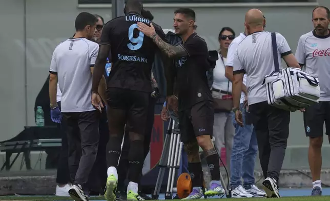Napoli's Romelu Lukaku is taken out after an injury during a friendly soccer match between Napoli and Olympiakos at the Teofilo Patini Stadium in Castel Di Sangro, Italy, Thursday, Aug. 14 , 2025. (Alessandro Garofalo/LaPresse via AP)