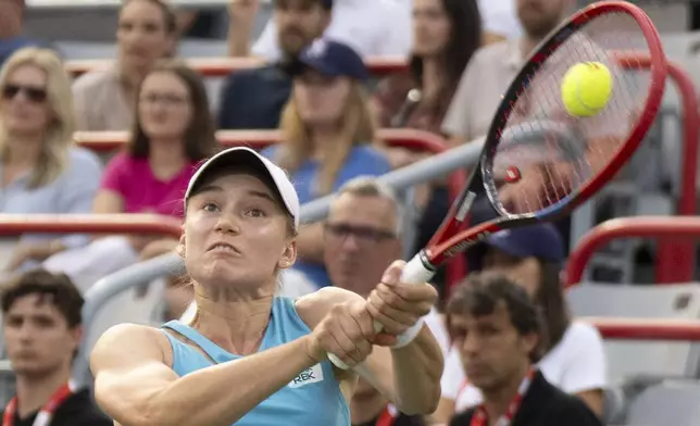 Elena Rybakina, of Kazakhstan, hits a return to Marta Kostyuk, of Ukraine, during quarterfinal action at the National Bank Open women's tennis tournament in Montreal, Monday, Aug. 4, 2025. (Christinne Muschi/The Canadian Press via AP)