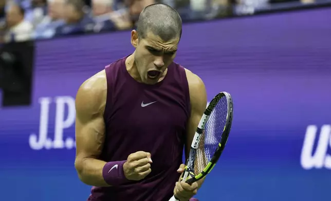 Carlos Alcaraz, of Spain, reacts against Reilly Opelka, of the United States, during the first round of the U.S. Open tennis championships, Monday, Aug. 25, 2025, in New York. (AP Photo/Adam Hunger)