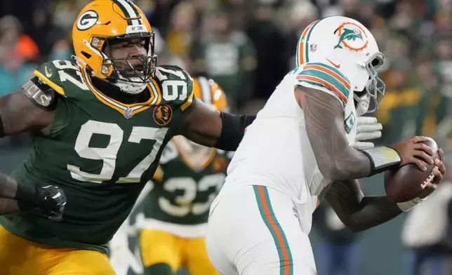 FILE - Green Bay Packers defensive tackle Kenny Clark (97) sacks Miami Dolphins quarterback Tua Tagovailoa during the second half of an NFL football game Thursday, Nov. 28, 2024, in Green Bay, Wis. (AP Photo/Morry Gash, File)