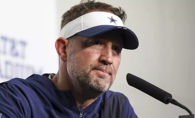 Dallas Cowboys head coach Brian Schottenheimer speaks to reporters following a preseason NFL football game against the Atlanta Falcons Friday, Aug. 22, 2025, in Arlington, Texas. (AP Photo/Gareth Patterson)