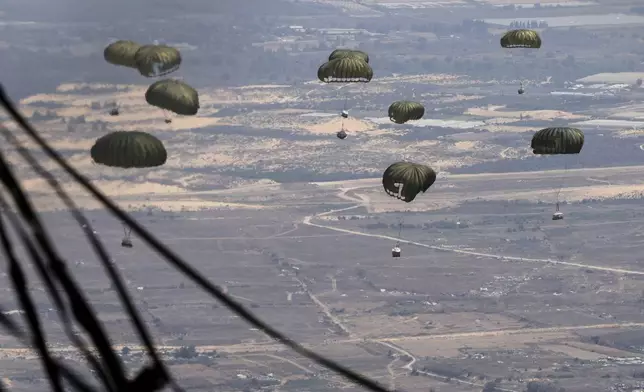 Containers of humanitarian aid are airdropped to Palestinians in the Gaza Strip from a Jordanian Air Force C-130 plane, Thursday, Aug. 7, 2025. (AP Photo/Raad Adayleh)