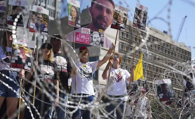 Families of hostages protest, demanding the release from Hamas captivity in the Gaza Strip, at the plaza known as the hostages square in Tel Aviv, Israel, Saturday, Aug. 2, 2025. (AP Photo/Ariel Schalit)
