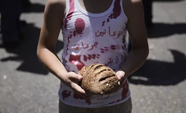 A child wearing a shirt stained with fake blood takes part in a demonstration in support of Palestinians in the Gaza Strip, amid the ongoing Israel-Hamas war, in Nablus, West Bank, Sunday, Aug. 3, 2025. (AP Photo/Majdi Mohammed)