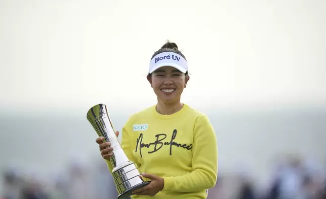 Miyu Yamashita of Japan poses with her trophy after winning the Women's British Open golf championship, at Royal Porthcawl Golf Club in Porthcawl, Wales, Sunday, Aug. 3, 2025. (AP Photo/Kin Cheung)