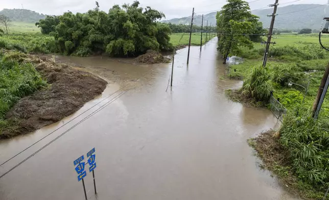 Water floods a road in Naguabo, Puerto Rico, as Hurricane Erin brings rain to the island, Sunday, Aug. 17, 2025. (AP Photo/Alejandro Granadillo)