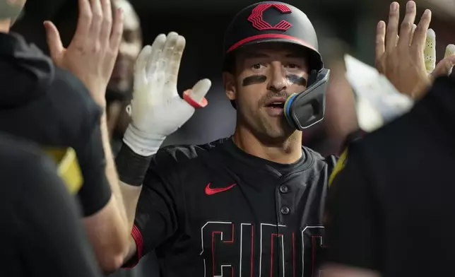 Cincinnati Reds' Spencer Steer celebrates in the dugout after hitting a solo home run during the sixth inning of a baseball game against the St. Louis Cardinals Friday, Aug. 29, 2025, in Cincinnati. (AP Photo/Carolyn Kaster)