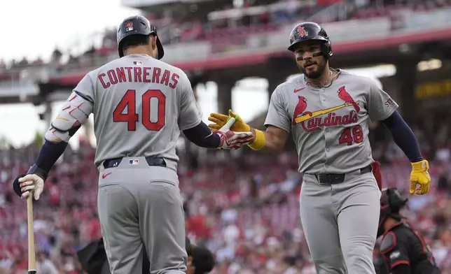 St. Louis Cardinals designated hitter Iván Herrera (48) celebrates with Willson Contreras (40) after hitting a solo home run during the first inning of a baseball game against the Cincinnati Reds Friday, Aug. 29, 2025, in Cincinnati. (AP Photo/Carolyn Kaster)