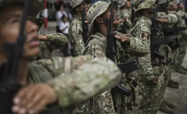 Peruvian soldiers form ranks during a flag ceremony in Santa Rosa, Peru, an island on the Amazon River at the center of a territorial dispute with Colombia, Sunday, Aug. 17, 2025. (AP Photo/Ivan Valencia)