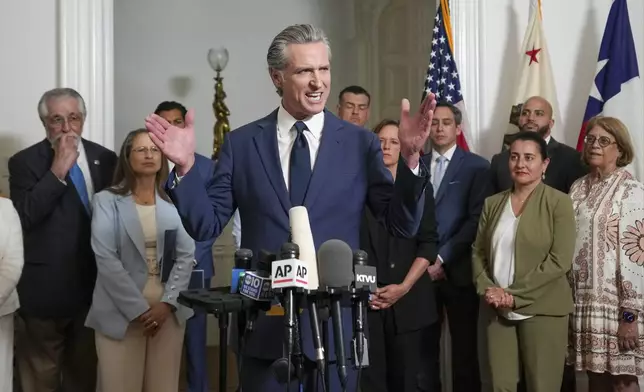 Accompanied by California and Texas lawmakers, California Gov. Gavin Newsom, center, discusses the push to schedule a special election to redraw California's Congressional voting districts, during a news conference in Sacramento, Calif., Friday Aug. 8, 2025. (AP Photo/Rich Pedroncelli)