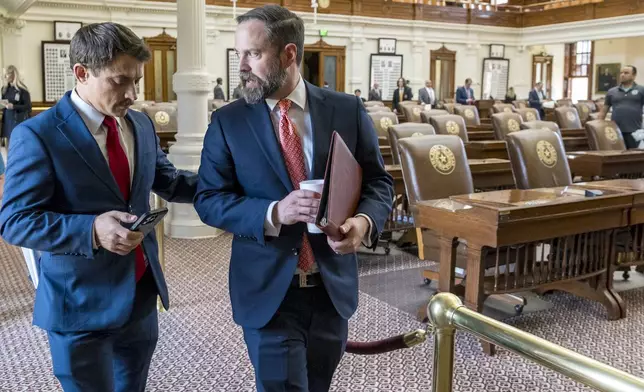 Texas House Speaker, Dustin Borrow, R - Lubbock, right, speaks with House Rep. Briscoe Cain, R - Deer Park, following a Republican Caucus meeting at the State Capitol, Friday, Aug. 8, 2025, in Austin, Texas. (AP Photo/Rodolfo Gonzalez)