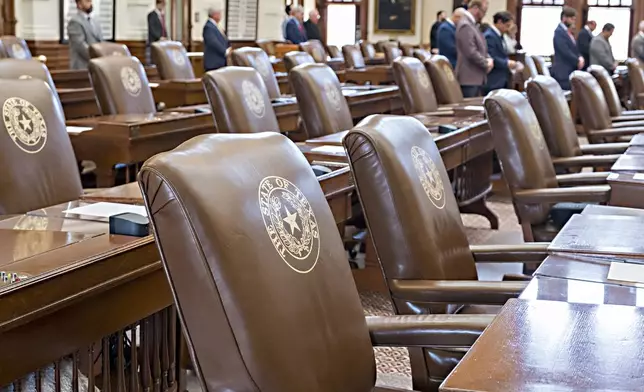 Empty chairs belonging to House Democrats remain empty during session convocation in protest to a redistricting map in the State Capitol, Tuesday, Aug. 5, 2025, in Austin, Texas. (AP Photo/Rodolfo Gonzalez)