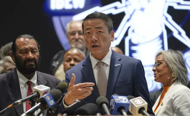 Democratic Texas Rep. Gene Wu, center, surrounded by other Texas House Democrats and Democratic members of Congress, speaks during a press conference at the Democratic Party in Warrenville, Ill., Monday, Aug. 4, 2025. (AP Photo/Nam Y. Huh)