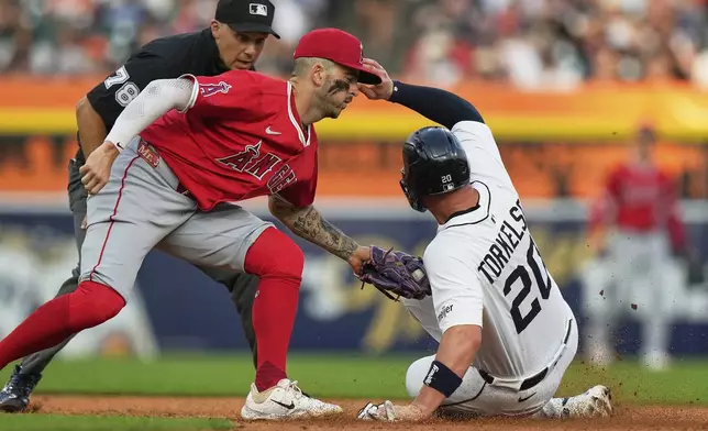 Detroit Tigers' Spencer Torkelson, right, is tagged out at second base by Los Angeles Angels shortstop Zach Neto, front left, during the fifth inning of a baseball game, Saturday, Aug. 9, 2025, in Detroit. (AP Photo/Ryan Sun)
