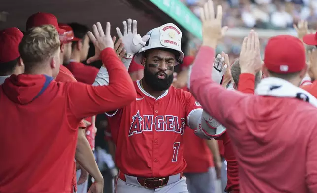 Los Angeles Angels' Jo Adell celebrates in the dugout after hitting a go-ahead three-run home run during the fourth inning of a baseball game against the Detroit Tigers, Saturday, Aug. 9, 2025, in Detroit. (AP Photo/Ryan Sun)