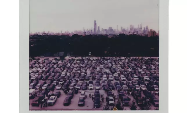 The city skyline can be seen as fans tailgate in a parking lot before a Chicago Cubs versus Chicago White Sox Crosstown Classic series baseball game Saturday, July 26, 2025, in Chicago. (AP Photo/Erin Hooley)