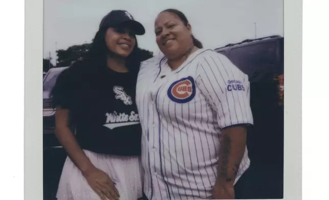 Flory Aquino, left, and Kristina Willer tailgate with friends and family before a Chicago Cubs versus Chicago White Sox Crosstown Classic series baseball game Saturday, July 26, 2025, in Chicago. (AP Photo/Erin Hooley)