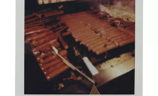 Hot dogs and onions are grilled during a Chicago Cubs versus Chicago White Sox Crosstown Classic series baseball game Sunday, July 27, 2025, in Chicago. (AP Photo/Erin Hooley)