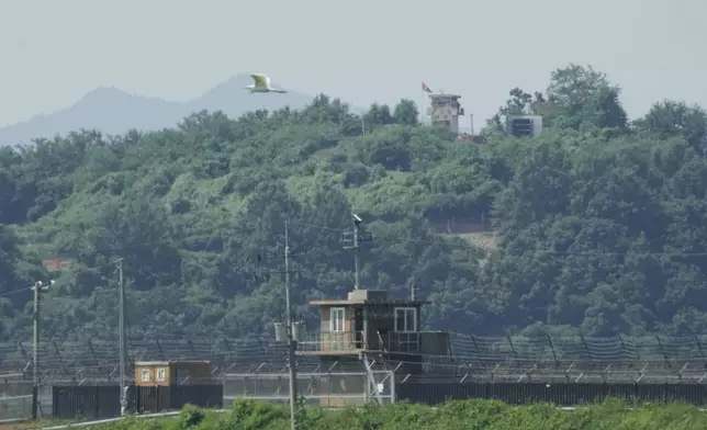 A North Korean military guard post, loudspeaker, top right, and South Korean military guard post, bottom, are seen from Paju, South Korea, near the border with North Korea, Monday, Aug. 4, 2025. (AP Photo/Ahn Young-joon)