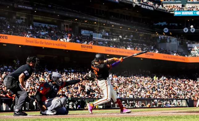 San Francisco Giants' Willy Adames (2) hits a solo home run during the first inning of a baseball game against the Baltimore Orioles in San Francisco, Saturday, Aug. 30, 2025. (Stephen Lam/San Francisco Chronicle via AP)