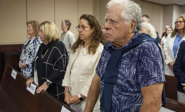 Phil Markel, right, and his family stand as jurors enter the courtroom for the trial of Donna Adelson on Friday, Aug. 22, 2025 in Tallahassee, Fla. (Alicia Devine/Tallahassee Democrat via AP, Pool)