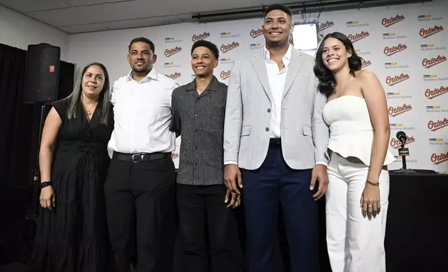 Baltimore Orioles' Samuel Basallo, second from right, poses for a photograph with his family and girlfriend after a press conference for his contract extension Saturday, Aug. 23, 2025, in Baltimore. (AP Photo/Terrance Williams)