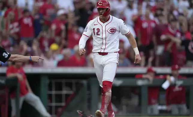 Cincinnati Reds' Austin Hays reacts after scoring on a double hit by Noelvi Marte during the fourth inning of a baseball game against the Philadelphia Phillies Wednesday, Aug. 13, 2025, in Cincinnati. (AP Photo/Carolyn Kaster)