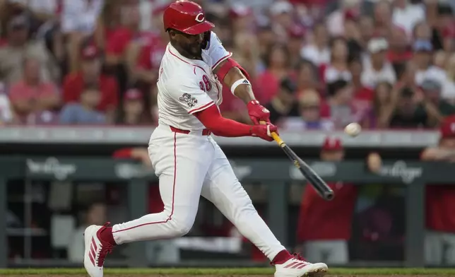 Cincinnati Reds' Miguel Andujar hits a grand slam home run during the seventh inning of a baseball game against the Philadelphia Phillies Wednesday, Aug. 13, 2025, in Cincinnati. (AP Photo/Carolyn Kaster)