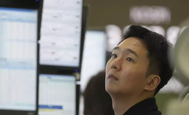 A dealer watches computer monitors at a dealing room of Hana Bank in Seoul, South Korea, Thursday, Aug. 28, 2025. (AP Photo/Lee Jin-man)