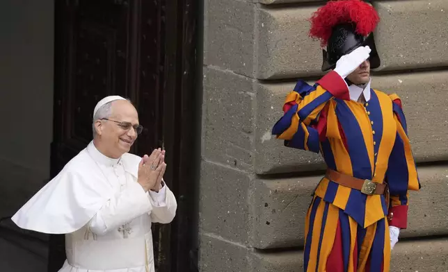 Pope Leo XIV greets faithful at the end of the Angelus prayer in Castel Gandolfo, Italy Sunday, Aug. 17, 2025. (AP Photo/Gregorio Borgia)