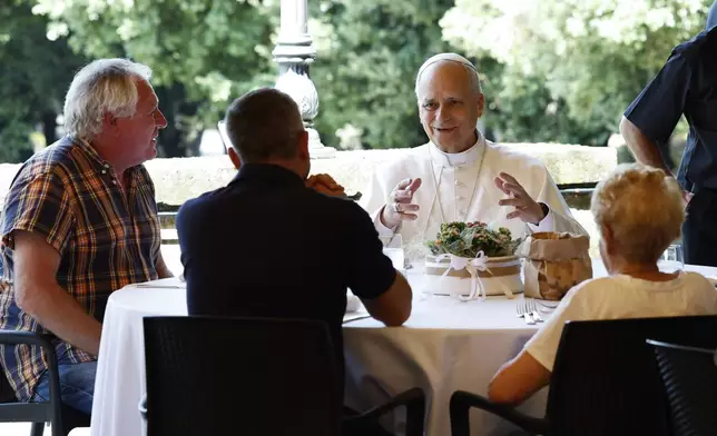 Pope Leo XIV attends a festive lunch with the poor of the Diocese of Albano Laziale at Borgo Laudato Si, in the garden of the Pontifical Villas in Castel Gandolfo, Italy, Sunday Aug. 17, 2025. (Remo Casilli/Pool via AP)