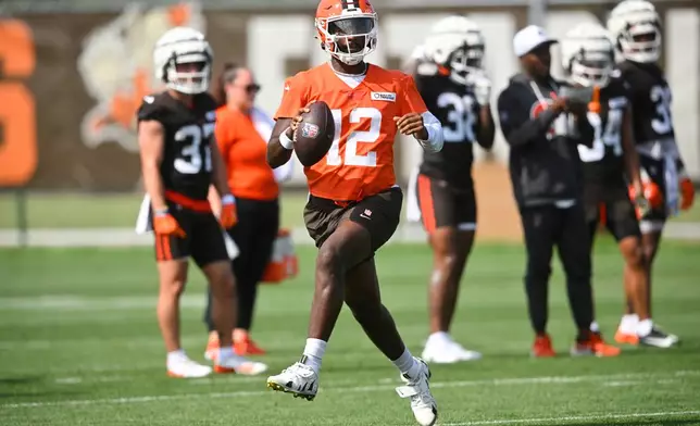 FILE - Cleveland Browns quarterback Shedeur Sanders (12) scrambles during practice at the team's NFL football training camp, Saturday, July 26, 2025, in Berea, Ohio. (AP Photo/David Richard, File)