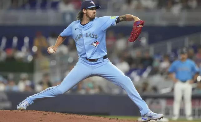 Toronto Blue Jays starting pitcher Kevin Gausman aims a pitch during the first inning of a baseball game against the Miami Marlins, Sunday, Aug. 24, 2025, in Miami. (AP Photo/Marta Lavandier)