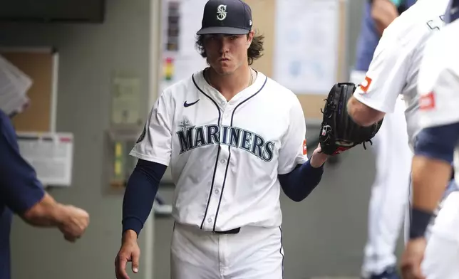 Seattle Mariners starting pitcher Bryan Woo reacts in the dugout after being relieved during the sixth inning of a baseball game against the San Diego Padres, Wednesday, Aug. 27, 2025, in Seattle. (AP Photo/Lindsey Wasson)