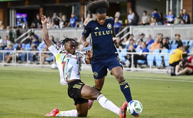 Vancouver Whitecaps forward Jayden Nelson, right, is slide-tackled by San Jose Earthquakes defender DeJuan Jones, left, during the first half of an MLS soccer match Saturday, Aug. 9, 2025, in San Jose, Calif. (AP Photo/Thien-An Truong)
