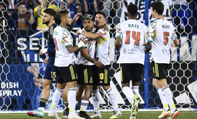 San Jose Earthquakes' Josef Martinez, middle left, reacts after scoring on a penalty kick against the Vancouver Whitecaps during the second half of an MLS soccer match Saturday, Aug. 9, 2025, in San Jose, Calif. (AP Photo/Thien-An Truong)