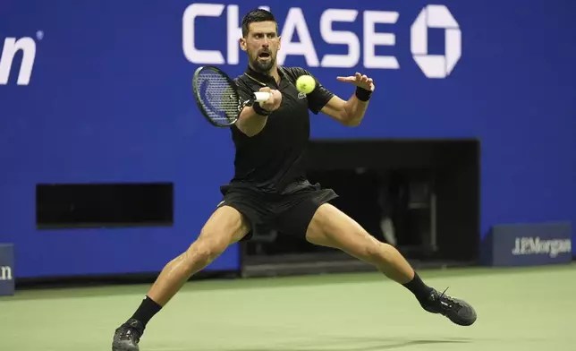 Novak Djokovic, of Serbia, returns a shot to Learner Tien, of the United States, during the first-round of the U.S. Open tennis championships, Sunday, Aug. 24, 2025, in New York. (AP Photo/Frank Franklin II)