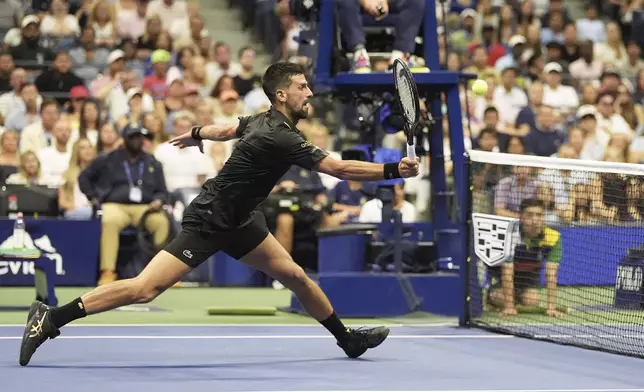 Novak Djokovic, of Serbia, returns a shot to Learner Tien, of the United States, during the first-round of the U.S. Open tennis championships, Sunday, Aug. 24, 2025, in New York. (AP Photo/Frank Franklin II)