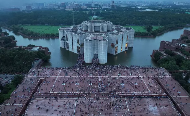 FILE- Protesters celebrate at the Parliament House premise after news of Prime Minister Sheikh Hasina's resignation, in Dhaka, Bangladesh, Aug. 5, 2024. (AP Photo/Fatima Tuj Johora, File)