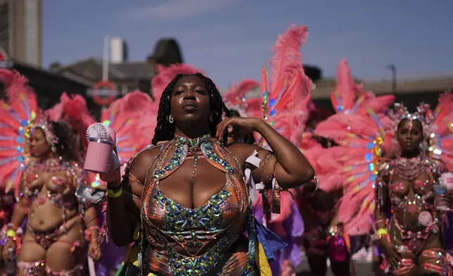 Revellers take part in the parade during the Notting Hill Carnival in London, Monday, Aug. 25, 2025, Europe's biggest street party and one of the largest carnivals in the world.(AP Photo/Alberto Pezzali)