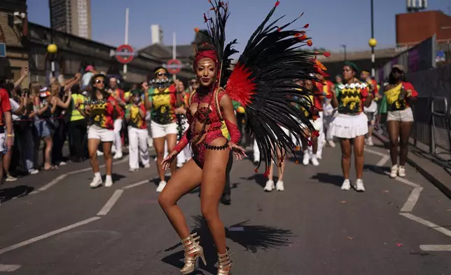 Revellers take part in the parade during the Notting Hill Carnival in London, Monday, Aug. 25, 2025, Europe's biggest street party and one of the largest carnivals in the world.(AP Photo/Alberto Pezzali)