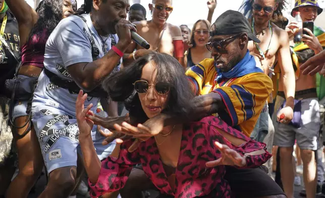 People sing and dance to celebrate Notting Hill Carnival in London, Monday, Aug. 25, 2025, Europe's biggest street party and one of the largest carnivals in the world.(AP Photo/Alberto Pezzali)