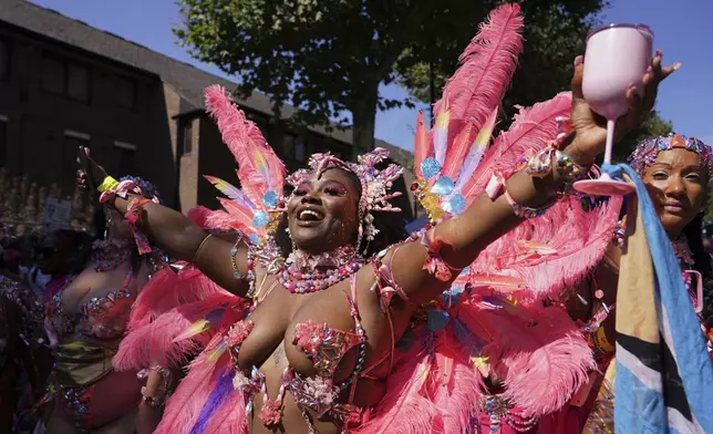 Revellers take part in the parade during the Notting Hill Carnival in London, Monday, Aug. 25, 2025, Europe's biggest street party and one of the largest carnivals in the world.(AP Photo/Alberto Pezzali)