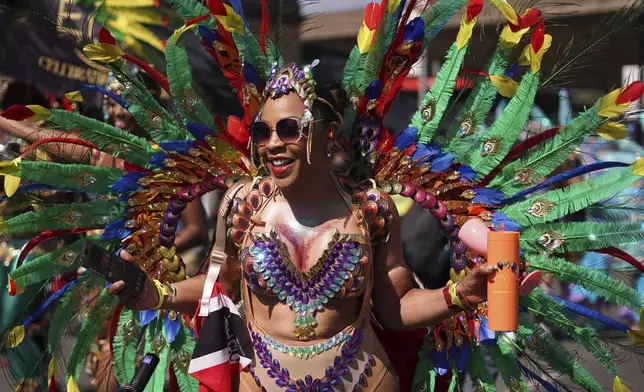 Revellers take part in the parade during the Notting Hill Carnival in London, Monday, Aug. 25, 2025, Europe's biggest street party and one of the largest carnivals in the world.(AP Photo/Alberto Pezzali)