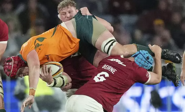 Australia's Harry Wilson is tackled by Tadhg Beirne, right, and Jac Morgan of the British &amp; Irish Lions during the third and final rugby union test between the Lions and the Wallabies in Sydney, Australia, Saturday, Aug. 2, 2025. (AP Photo/Mark Baker)