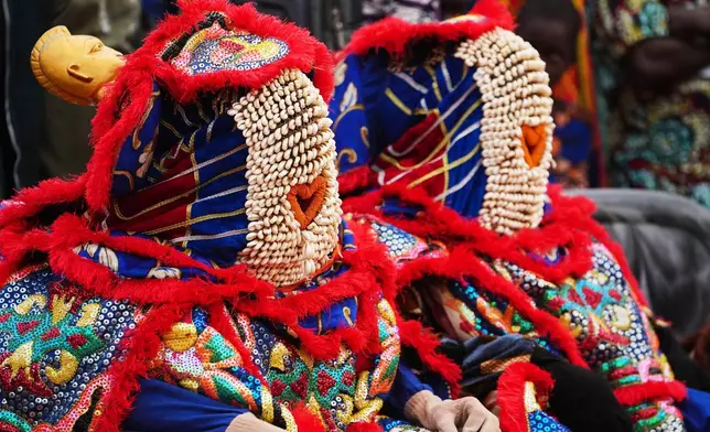People dress in costumes attend the mask festival in Porto Novo, Benin , Saturday, Aug. 2, 2025. (AP Photo/Sunday Alamba)