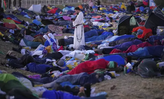 Young people wake up after spending the night at the Tor Vergata field in Rome as they participate in the Youths Jubilee, Sunday, Aug. 3, 2025. (AP Photo/Andrew Medichini)